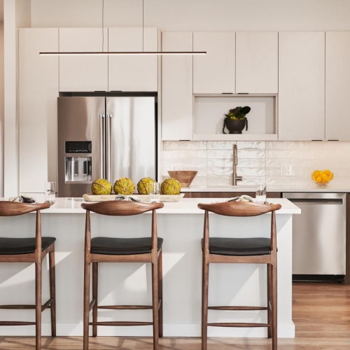 Settle into comfort at Life Time Living Burlington a kitchen with white cabinets