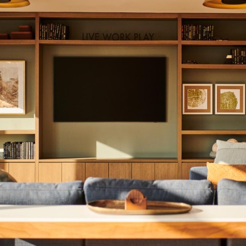 Settle into comfort at Life Time Living Burlington a person sitting on a couch in a living room